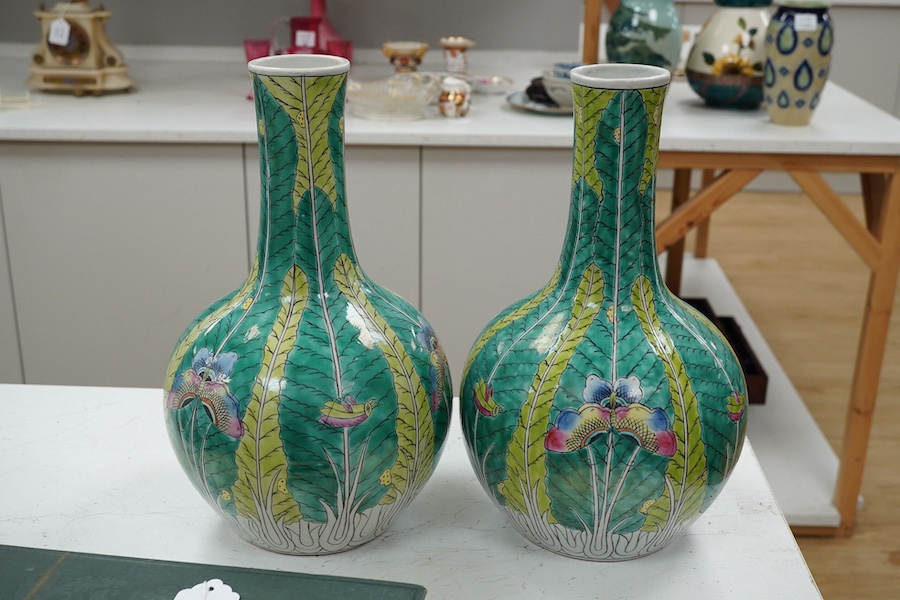 A pair of modern Chinese leaf and butterfly decorated bottle vases, 37cm high. Condition - good